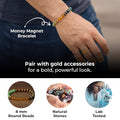Money Magnet Bracelet worn on the wrist with gold accessories, showing 8mm round natural lab-tested beads