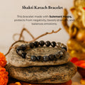 Sulemani Hakik Bracelet (Shakti Kavach) on stacked stones with marigold flowers, black agate beads